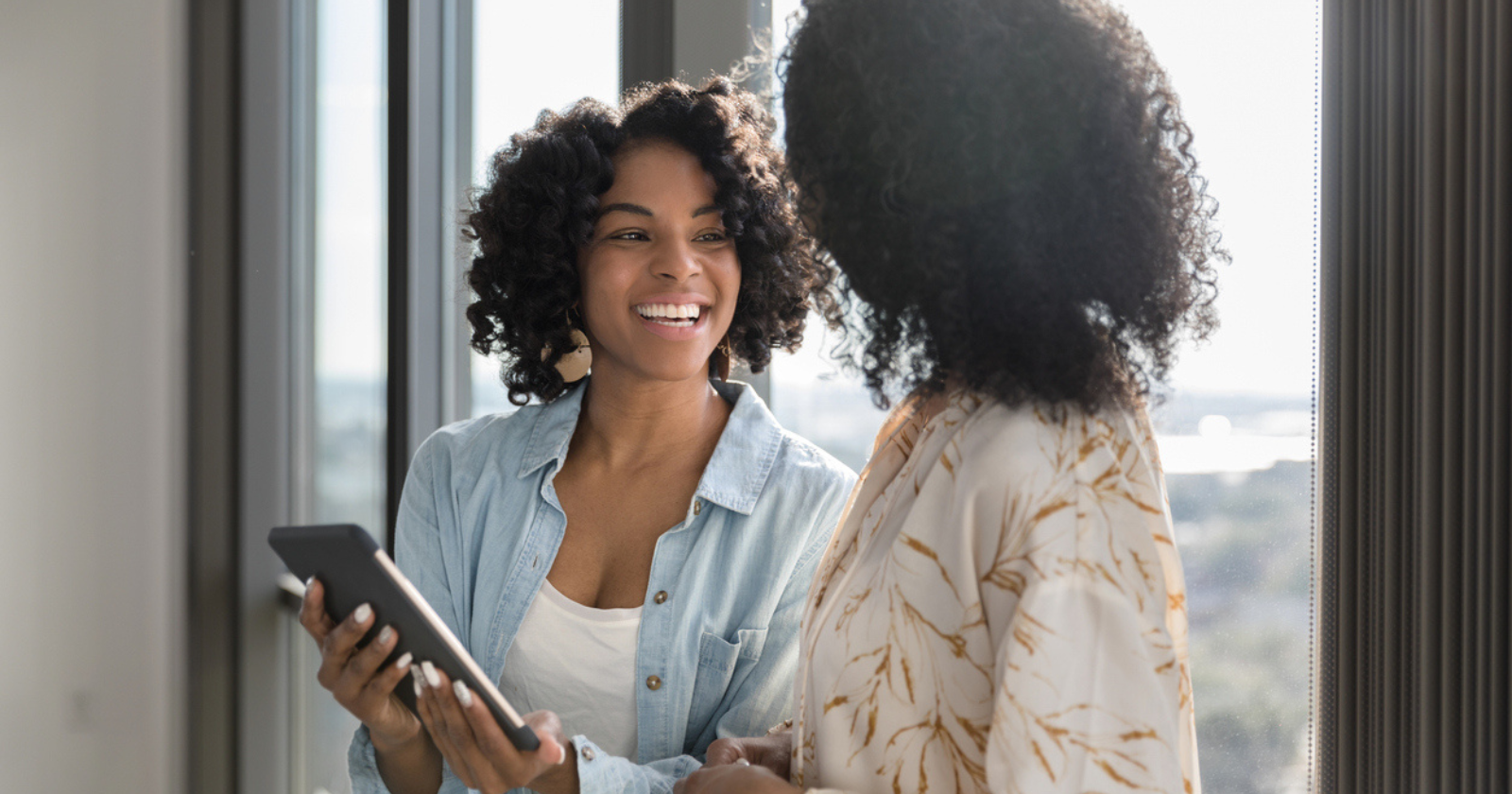 coworkers looking at a device screen