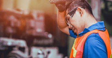industrial worker wiping sweat off his brows