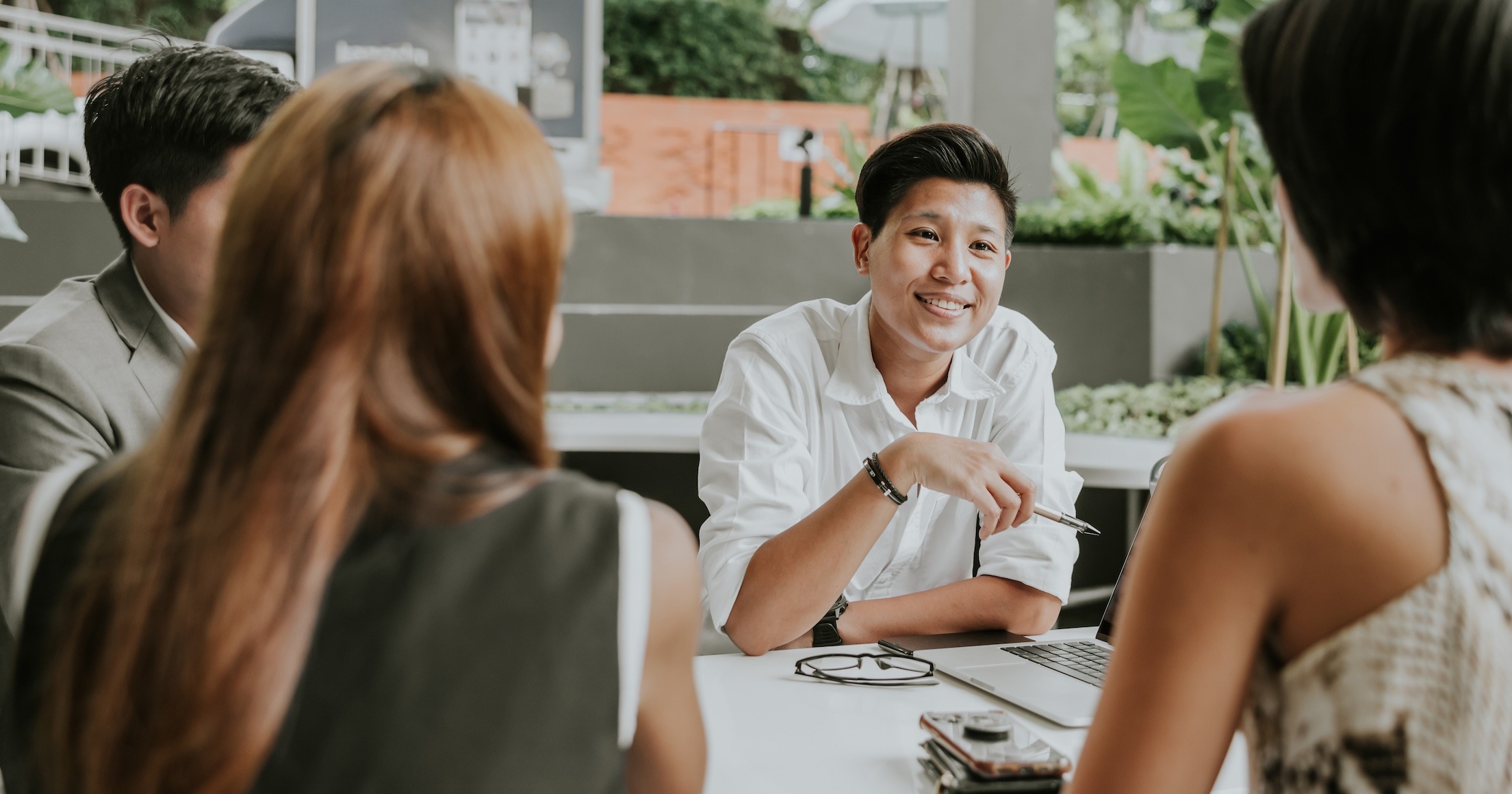 Group of people talking about workplace wellbeing after being part of workplace wellbeing programs and workplace counselling services