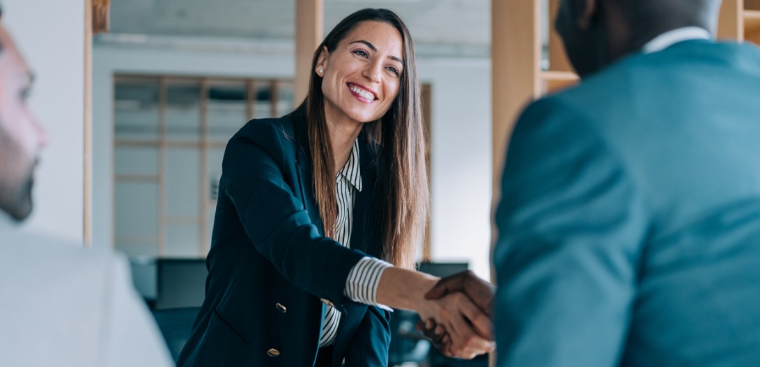 female manager shaking client's hand